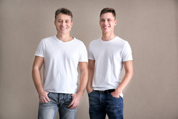 Men in color t-shirt on light background. Mockup for design