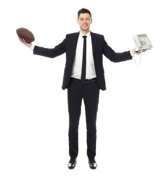 Businessman with rugby ball and telephone on white background