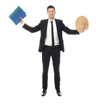 Businessman with notebooks and paint palette on white background