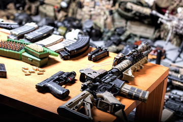 A lot of rifles, guns, grenades, helmets, gas masks, ammunition, vests, devices and other military gear. - obrazy, fototapety, plakaty