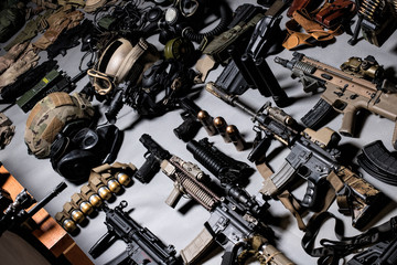 A lot of rifles, guns, grenades, helmets, gas masks, ammunition, vests, devices and other military gear.