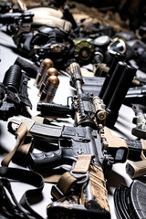 Fototapeta premium A lot of rifles, guns, grenades, helmets, gas masks, ammunition, vests, devices and other military gear.