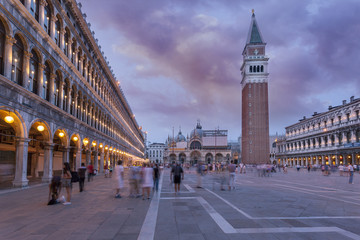 Fototapeta na wymiar St. Mark Square Campanile and Doges Palace. Clock Tower of Venice against sunset sky, Italy.