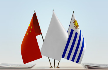 Flags of China and Uruguay with a white flag in the middle
