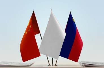Flags of China and Liechtenstein with a white flag in the middle