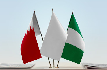 Flags of Bahrain and Nigeria with a white flag in the middle