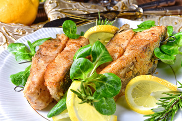 Fried carp fillet on wintry salad