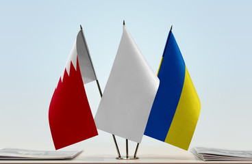 Flags of Bahrain and Ukraine with a white flag in the middle