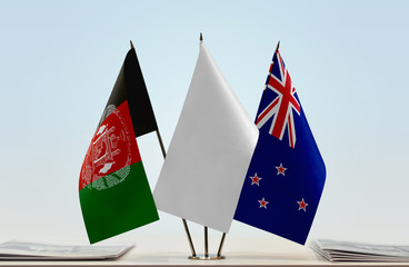 Flags of Afghanistan and New Zealand with a white flag in the middle