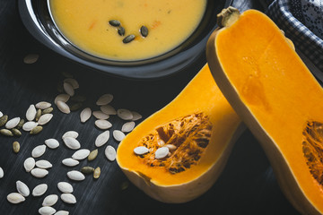 Pumpkin soup on a dark wooden background