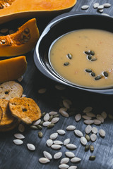 Pumpkin soup on a dark wooden background