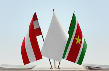 Flags of Austria and Suriname with a white flag in the middle