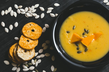 Pumpkin soup on a dark wooden background