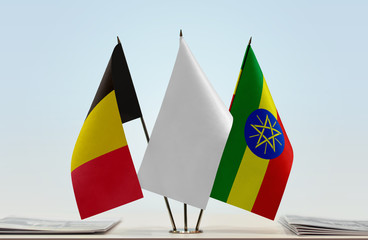 Flags of Belgium and Ethiopia with a white flag in the middle