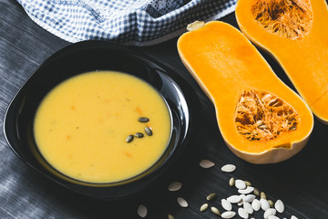 Pumpkin soup on a dark wooden background