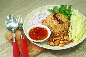 Thai Cuisine and Food, Thai Traditional Crispy Catfish Salad Served With Green Oak, Shredded Green Mango, Red Onion, Cabbage, Chili, Peanut and Spicy Sauce