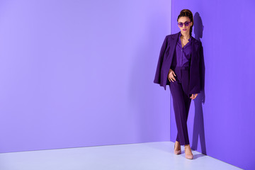 fashionable african american girl posing in trendy purple suit, ultra violet trend