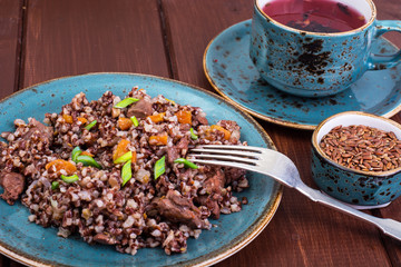 Garnish of red rice, garlic, vegetables, chicken meat