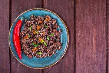 Garnish of red rice, garlic, vegetables, chicken meat