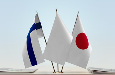 Flags of Finland and Japan with a white flag in the middle