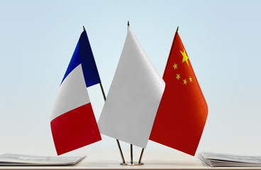 Flags of France and China with a white flag in the middle