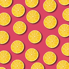 Lemon slices pattern on vibrant pomegranate color background. Minimal flat lay food texture 