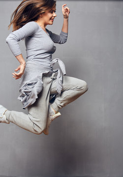Jumping woman wearing sports wear.