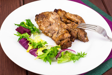 Concept of protein-carbohydrate nutrition. Chicken meat with lettuce