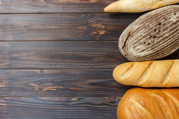 Fresh Bread assortment on wooden surface background