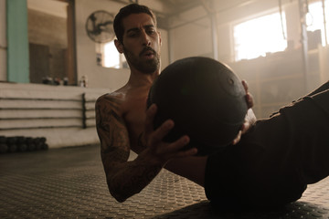 Sportsman working out with fitness ball