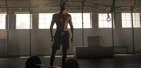 Fototapeta na wymiar Weight lifter standing in gym