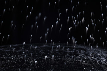 Dark background shot of rain falling