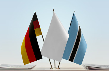 Flags of Germany and Botswana with a white flag in the middle