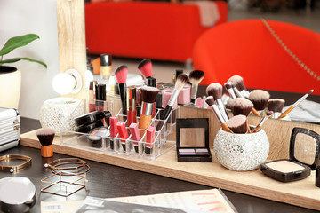 Table with cosmetics in modern makeup room