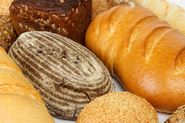Bread background, top view of white, black and rye loaves