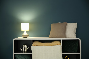 Shelving with stylish lamp in living room