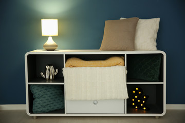 Shelving with stylish lamp in living room