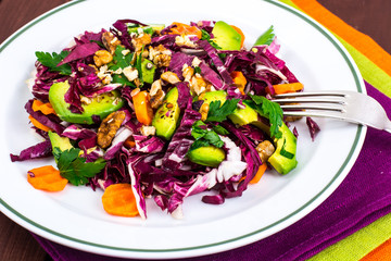 Healthy food. Salad of fresh vegetables with avocados and nuts