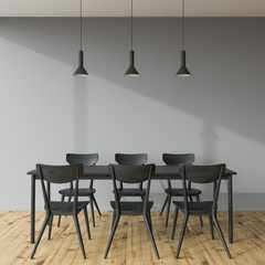 Fototapeta na wymiar Dark gray dining table in a gray room