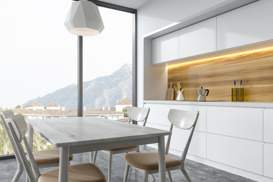 Wooden Dining Table In A White Kitchen Corner