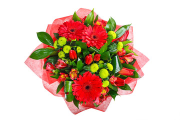 Bouquet of gerberas, tulips, bush chrysanthemums, Ruscus, alstroemeria, aspidistra. In red packing. A holiday, a gift for a woman. Big and smart. View from above Isolated