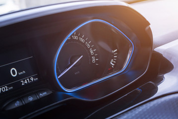 Car speedometer close up. Modern blue interior design.