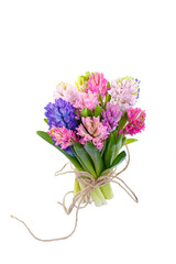 Lilac, blue, pink, raspberry hyacinths in a small, low bouquet, tied with a rope. A holiday, a gift for a woman. Smart. Side view. Isolated