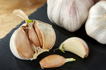 Garlic close up on black piece of board, shallow depth of field, selective focus, macro