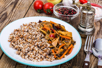 Vegetarian dish. Grain porridge with stewed vegetables