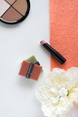 Make up products on the white and peach color background