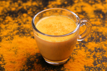 Indian turmeric milk with saffron, cardamom and turmeric. Copyspace