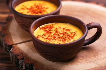 Indian turmeric milk with saffron, cardamom and turmeric. Copyspace