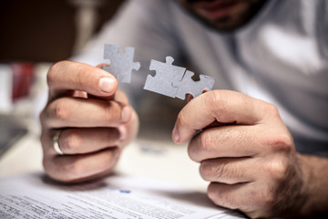 Focus image of puzzle in businessman hand. Close up.