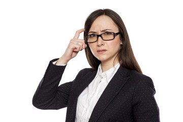 Confused businesswoman with questioning gesture posing on white background - obrazy, fototapety, plakaty
